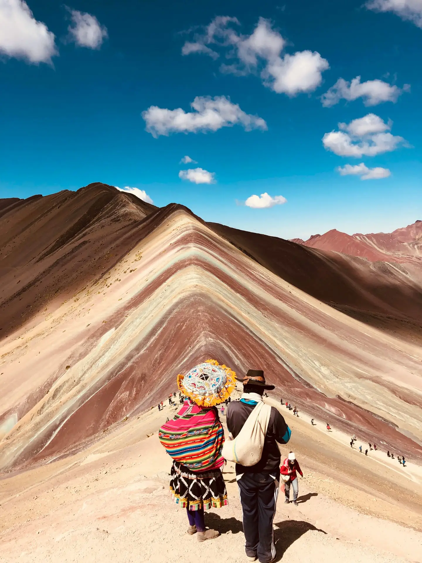 Voyageurs devant la montagne aux sept couleurs de Vinicunca au Pérou